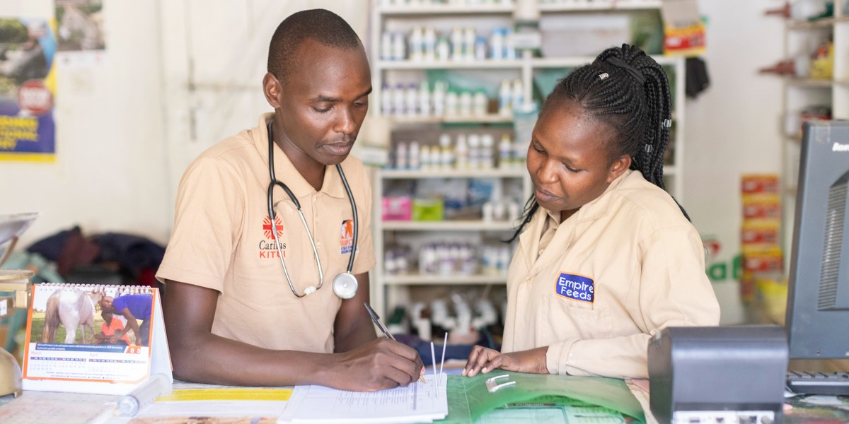 A vet mentors a trainee agrovet at a store in Kenya