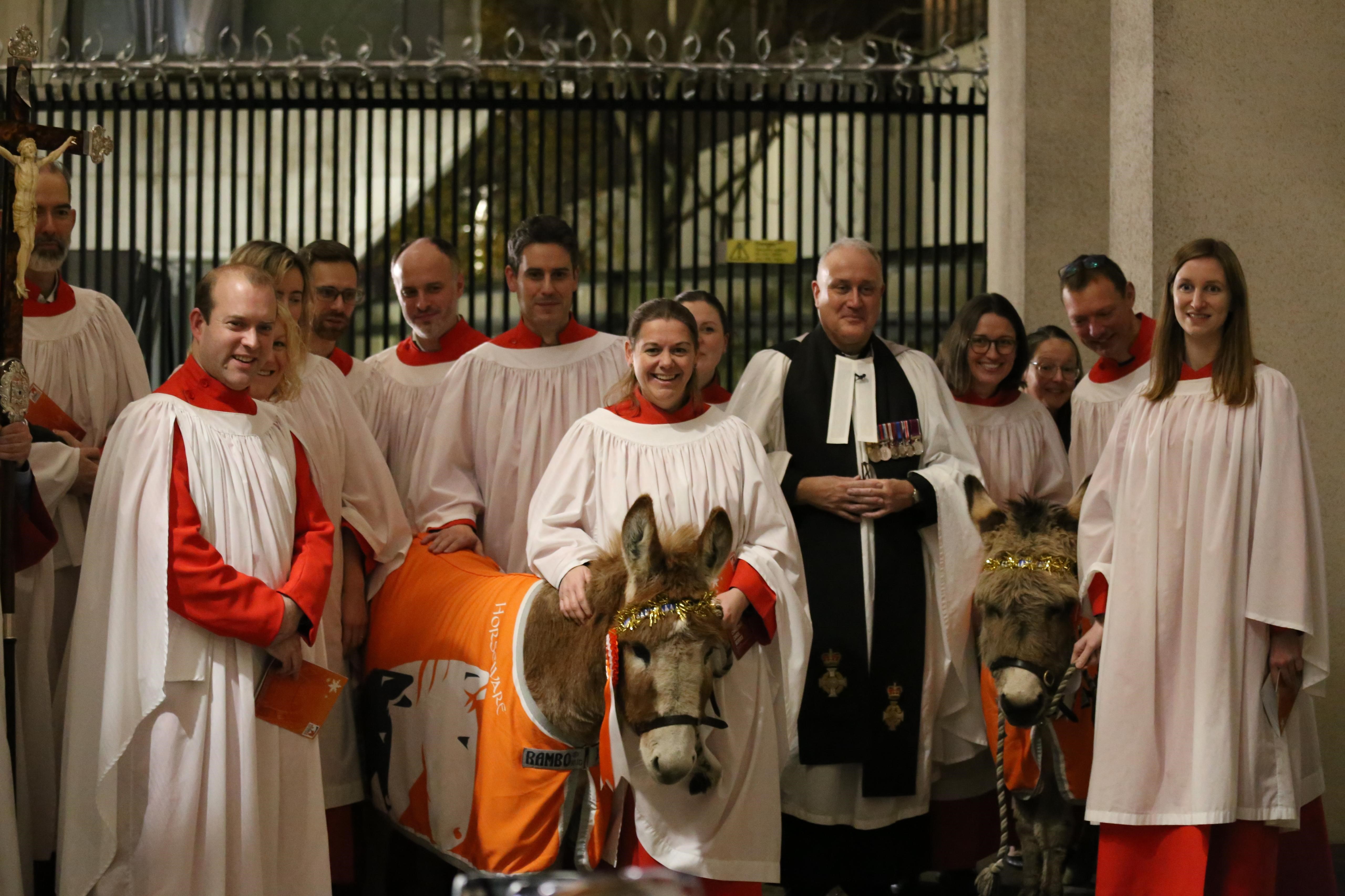 Choir with donkeys at charity carol service