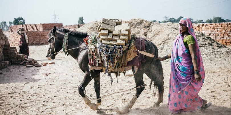Woman accompanies her donkey in Pakistan brick kiln Woman accompanies her donkey in Pakistan brick kiln