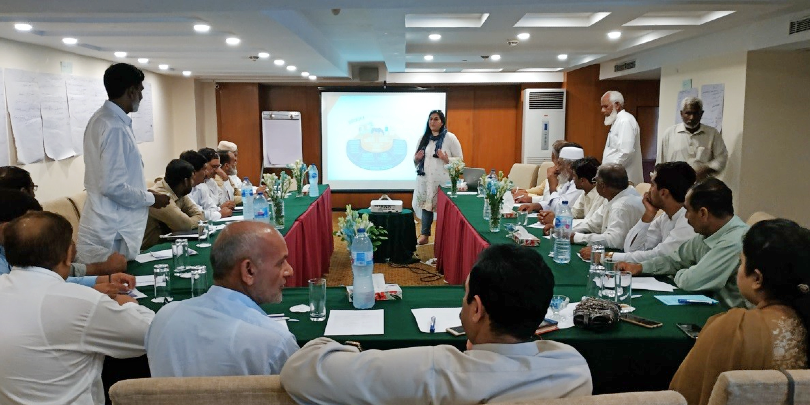 Sana facilitating a consultation with all field teams on how Brooke can effectively contribute to positively changing equine owners' behaviour within communities Woman presenting to community members in Pakistan
