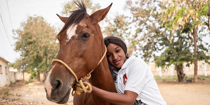 Fatou Toure, Senegal's first certified female farrier, with a horse Fatou Toure, Senegal's first certified female farrier, with a horse