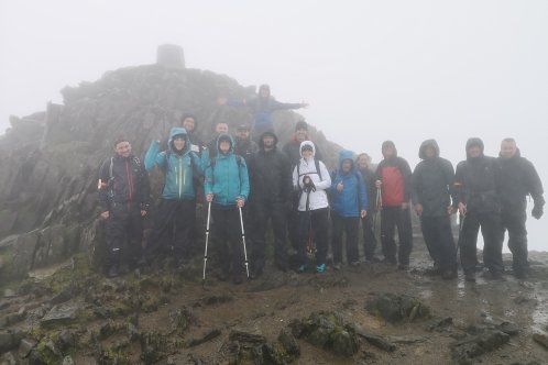 A group of people on top of a misty mountain