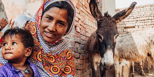 Brick kiln worker Rafia Arshad with her family, at the Maliktariq brick kiln just outside of Lahore, Pakistan
