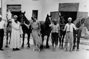 An old black and white photograph shows Dorothy Brooke (centre) in the yard of the SPCA with some of the war horses she rescued in the 1930s. Cairo, Egypt