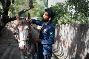 Brooke staff standing with horse