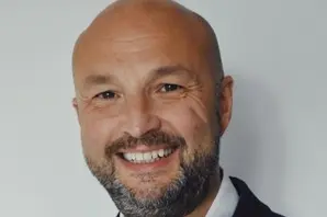 Chris Wainwright, Brooke CEO pictured smiling in a white shirt and black jacket.