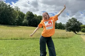 Brooke supporter in orange t-shirt in field