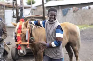 Boy hugging horse in Ethiopia