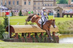 Gemma Stevens and horse jumping on eventing course at Badminton Horse Trials 2025.
