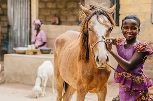A young woman with her horse