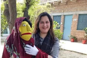 Woman holding a puppet in Pakistan