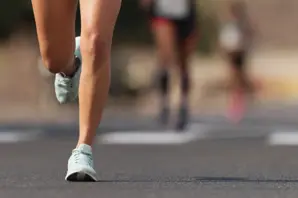 An image of a woman's leg and feet running