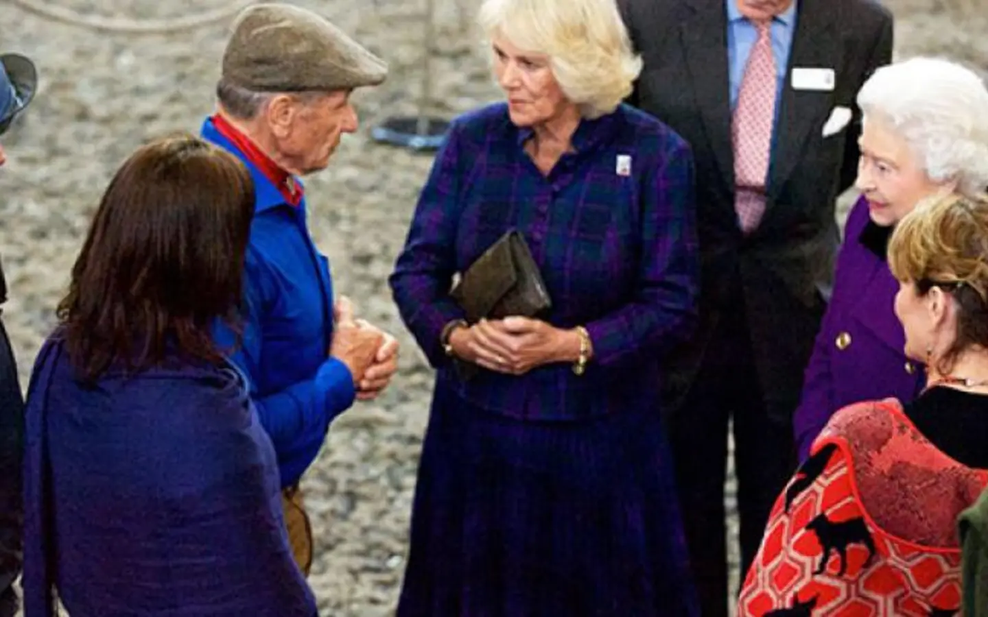 HRH The Queen stands with Queen Elizabeth II while talking to Monty Roberts