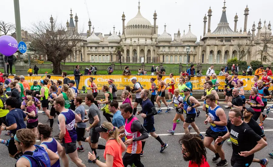 group of marathon runners in front of Brighton Pavillion