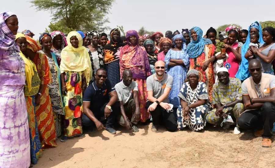 Brooke CEO Chris Wainwright (centre) meets with a community involved with Brooke's biogas project.
