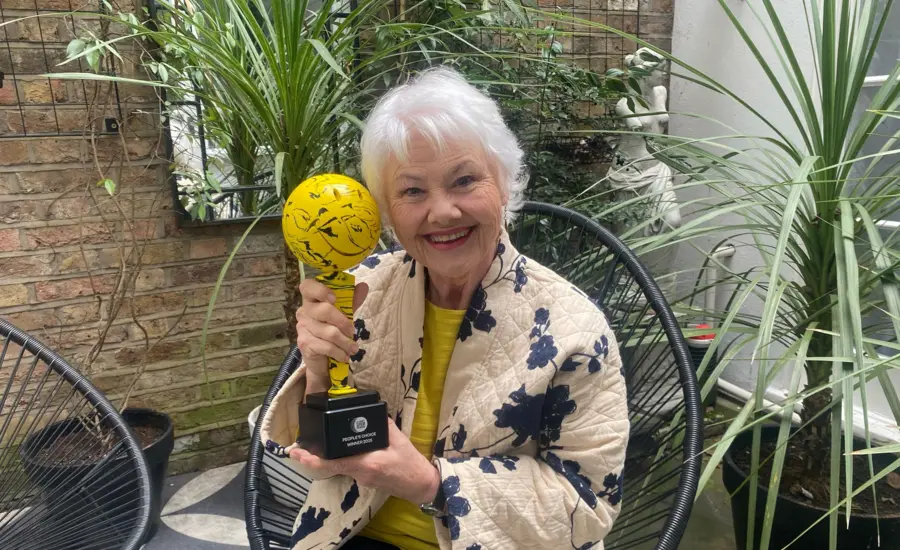 Annette Badland holding charity's film award trophy