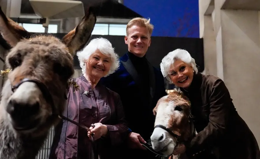 Annette Badland and Dr Scott with donkeys at Brooke's Christmas carol concert 