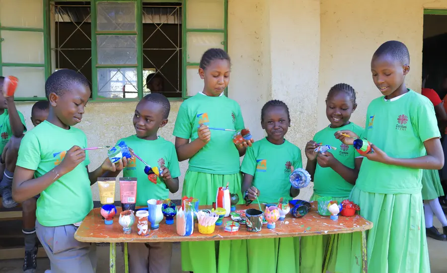 School children in Kenya decorate plastic bottles
