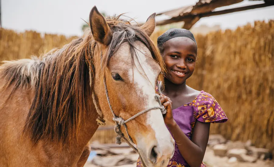 Girl and horse in Senegal 