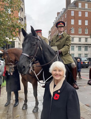 Annette stands with cavalry soldiers and horses at this year's Service Annette with cavalry soldiers and horses