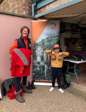 Attendees of a tack sale in Jersey in front of Brooke stand