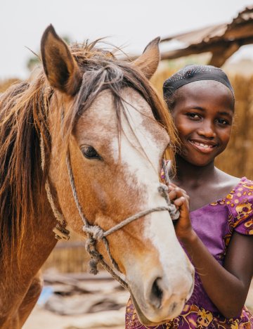 Girl and horse in Senegal