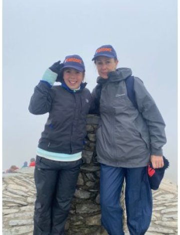 Young girl and mother pose at top of Snowdon