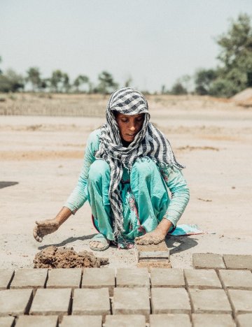 A woman working in Hamza Brick Kiln in Pakistan to feed her four children A woman working in Hamza Brick Kiln in Pakistan to feed her four children