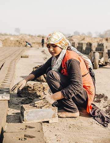 Young woman working at a Pakistan brick kiln
