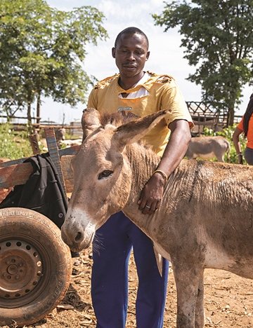 Amos and a donkey stand together