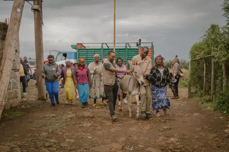 A community in Kenya walks with a donkey