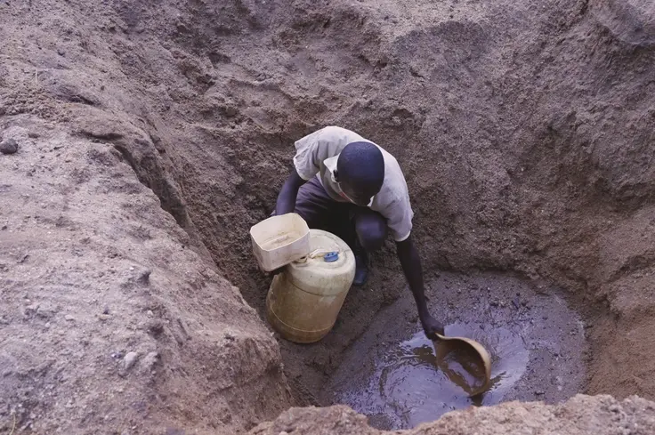Drought 2. Dennis collecting water.jpg