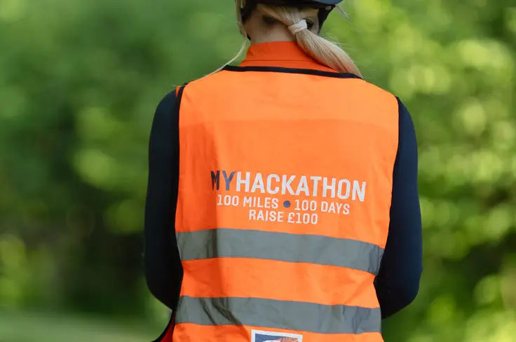 ThisEsme in a high-vis vest hacking on a horse for Brooke.